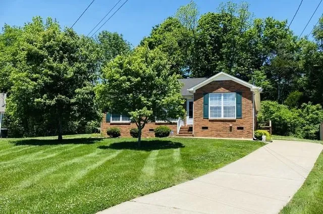 a front view of a house with a yard