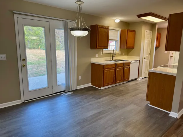a view of kitchen with granite countertop cabinets and wooden floor