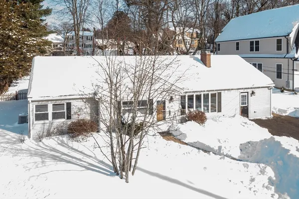 a view of a house with snow on the road