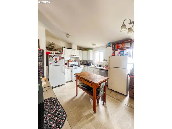 a living room with furniture and a dining table