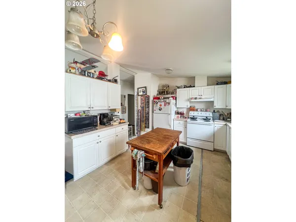 a room with furniture and white appliances
