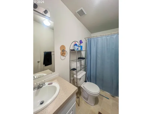 a white toilet sitting next to a bathroom sink