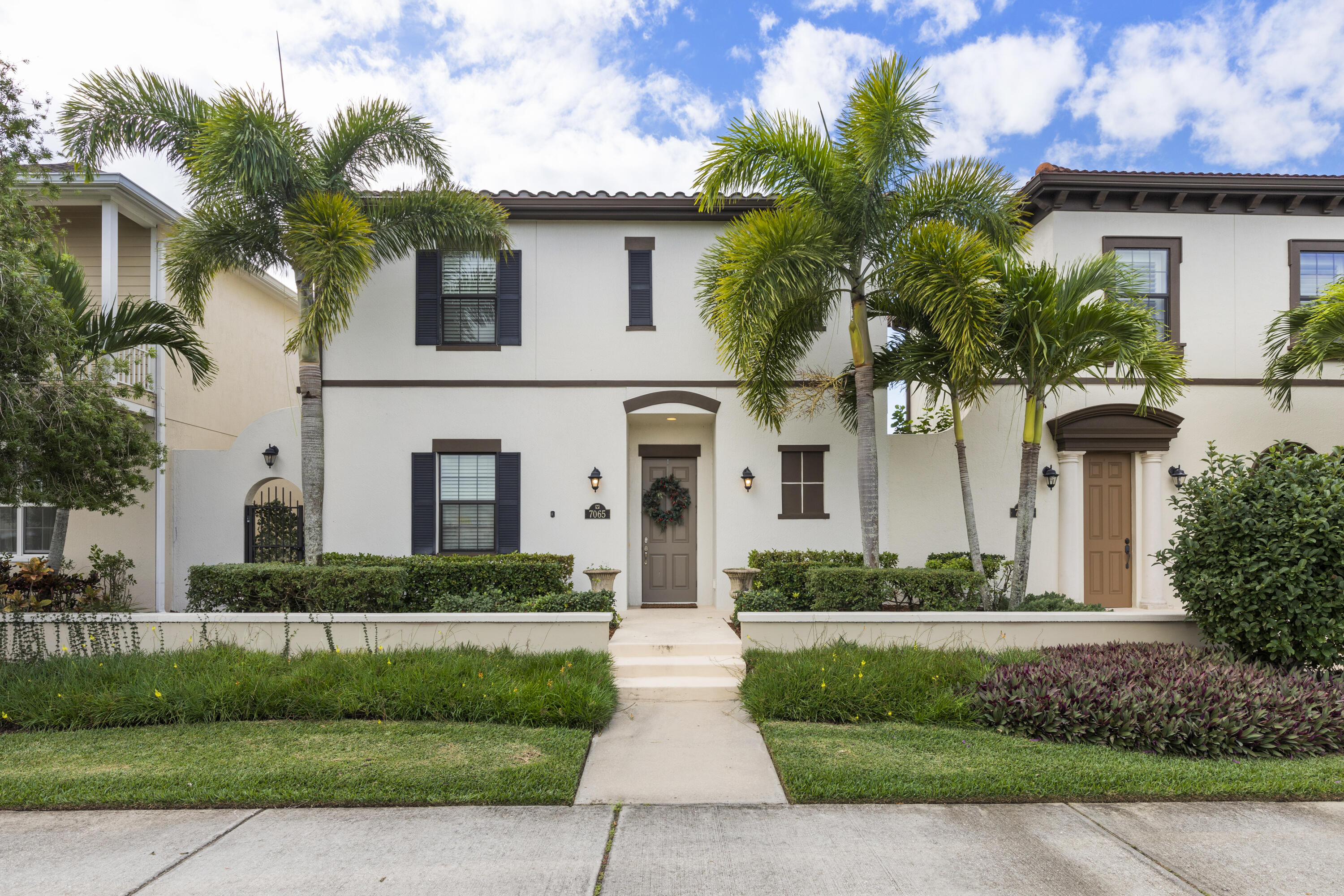 a front view of a house with a garden