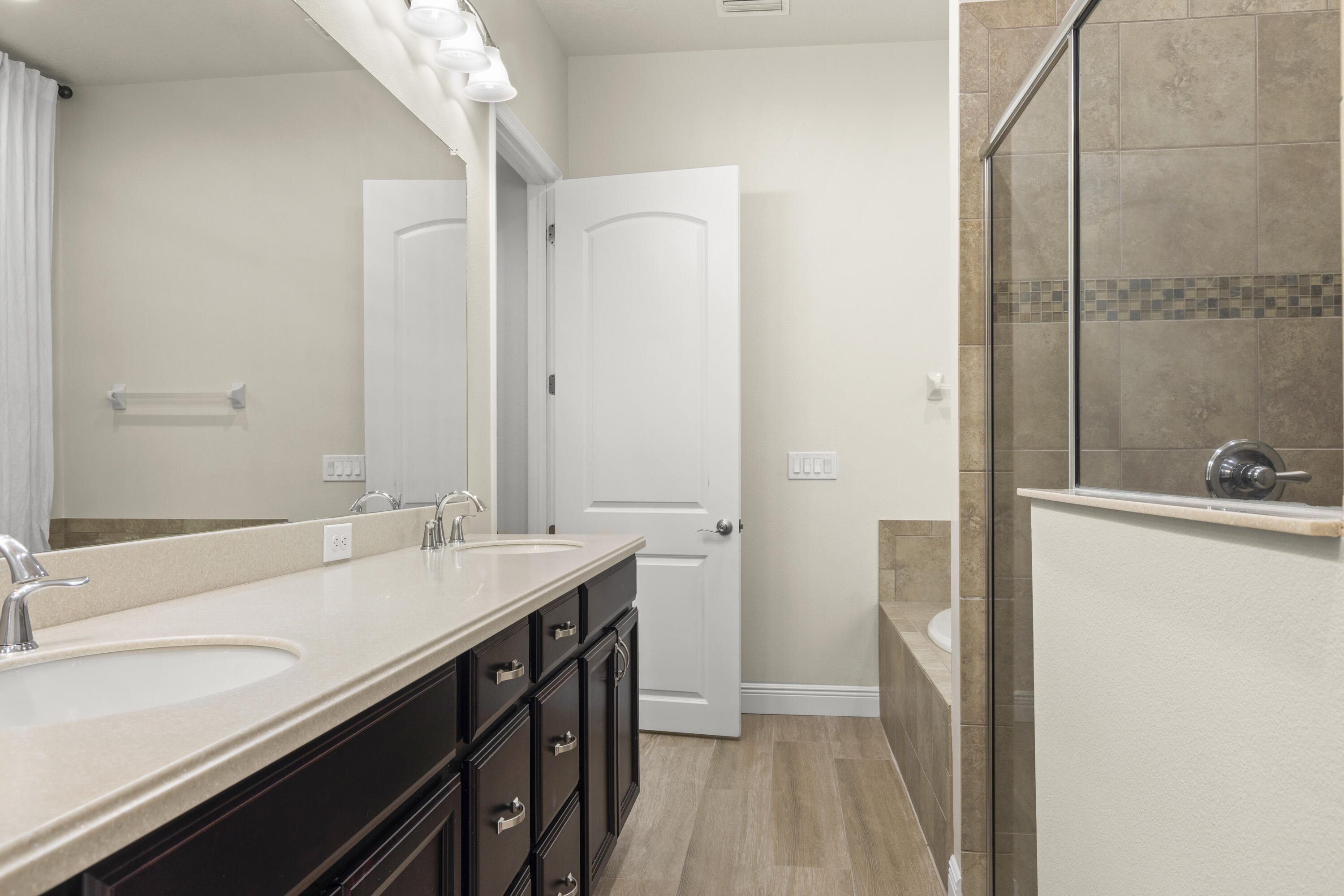 7065 Primavera Lane Melbourne, FL 32940 - Photo 16 of 40 a bathroom with a sink a mirror and a shower