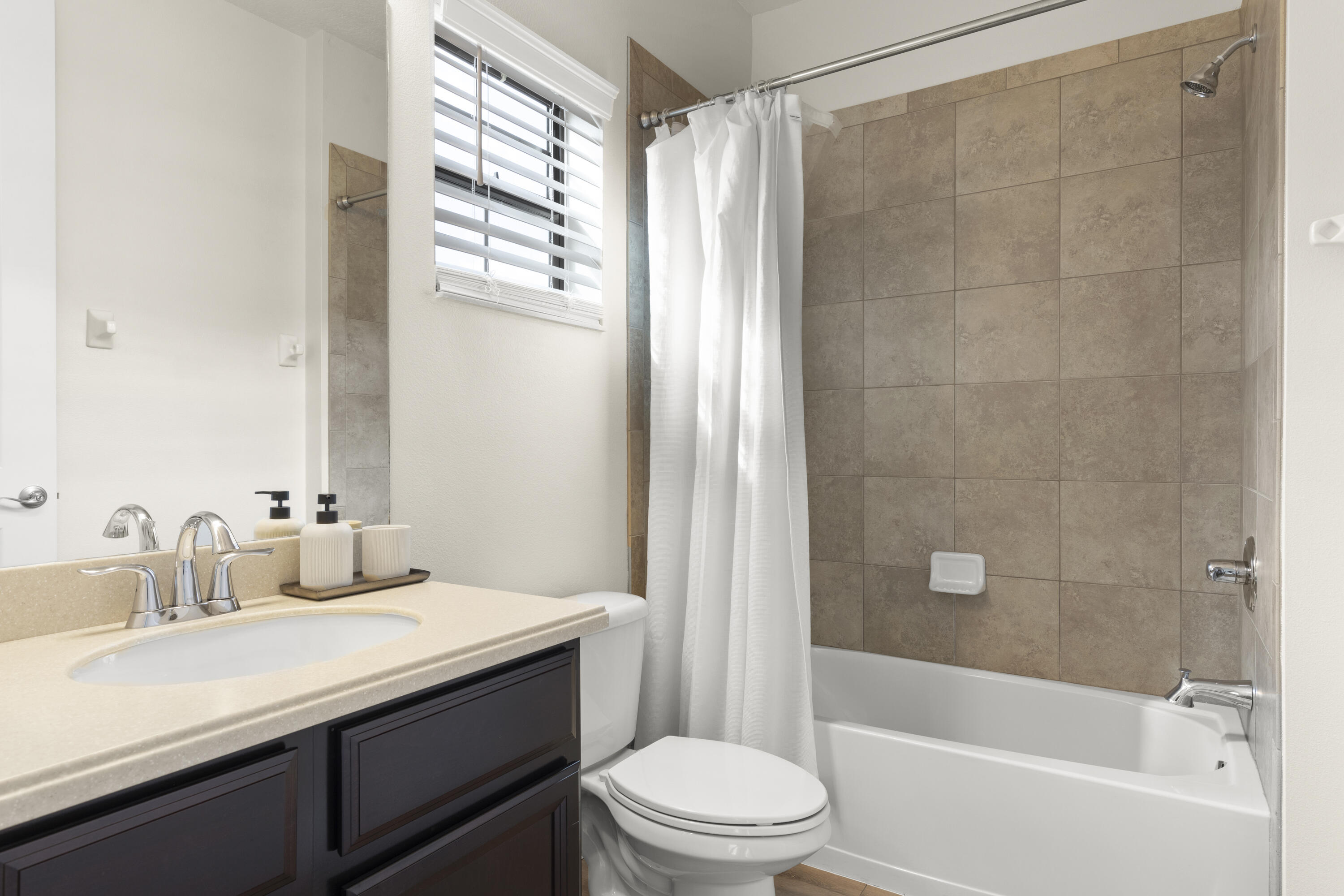 7065 Primavera Lane Melbourne, FL 32940 - Photo 19 of 40 a bathroom with a sink a toilet and shower