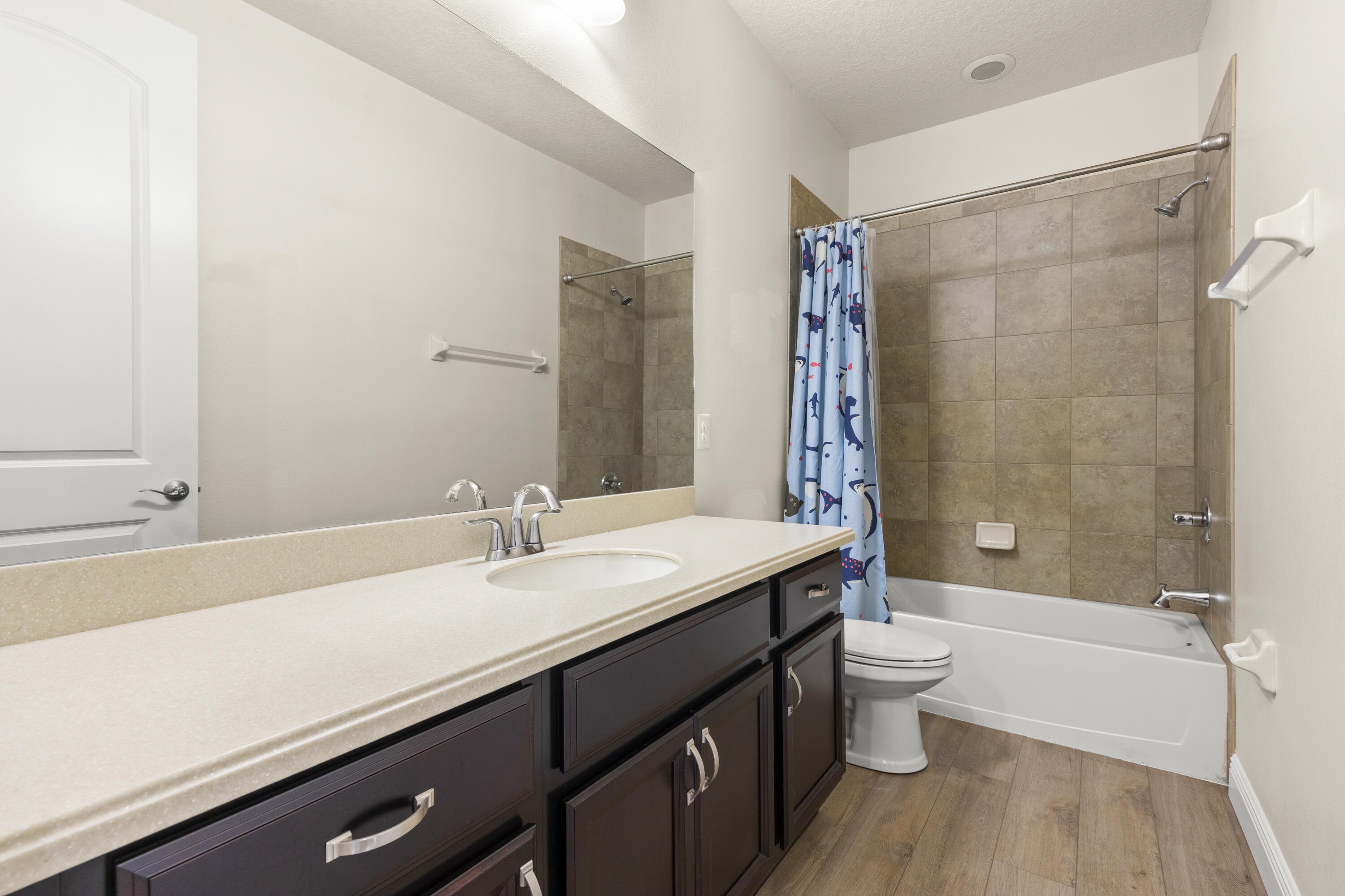 7065 Primavera Lane Melbourne, FL 32940 - Photo 21 of 40 a bathroom with a sink a toilet and shower