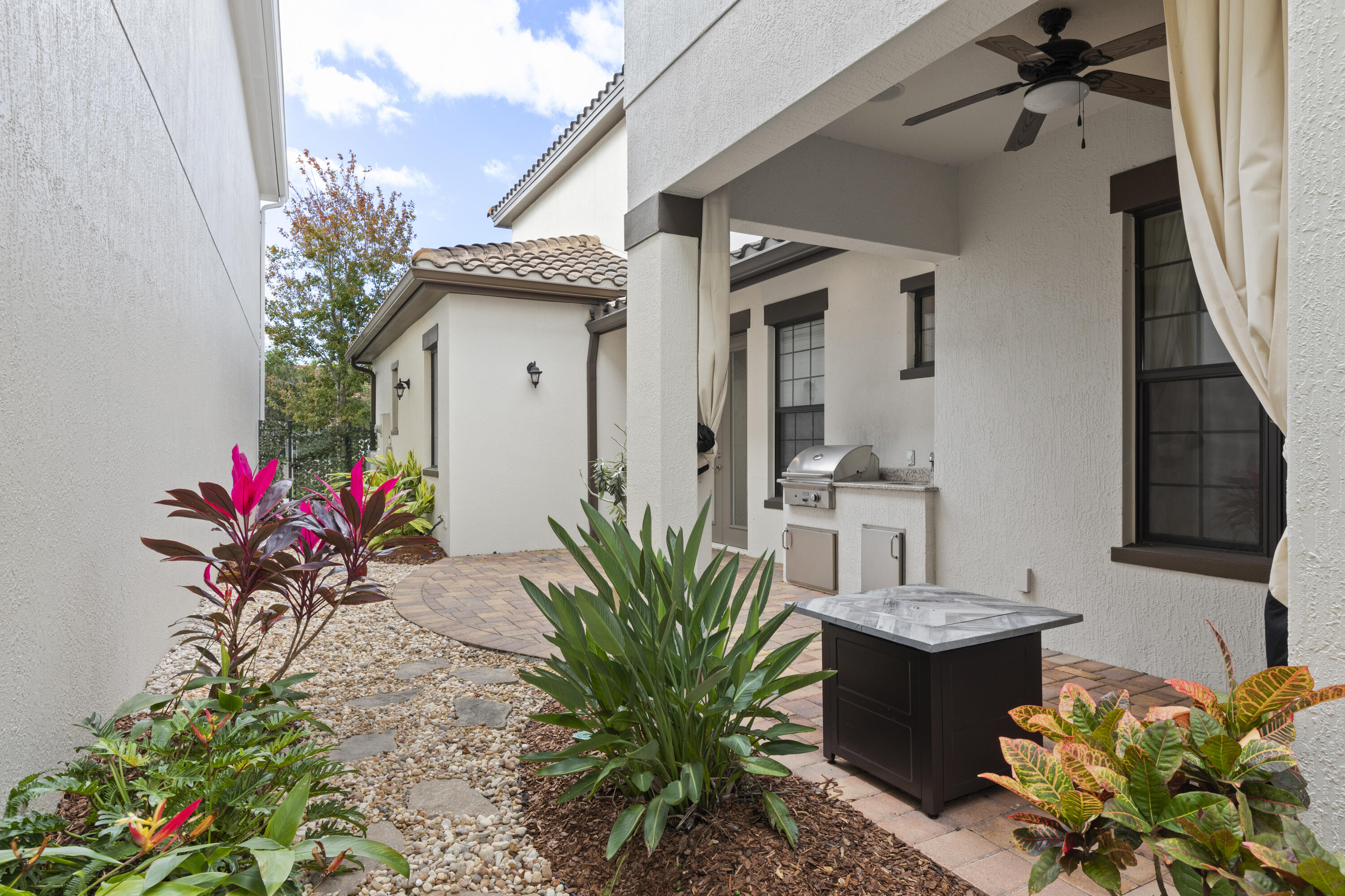 7065 Primavera Lane Melbourne, FL 32940 - Photo 5 of 40 a vase of flowers sitting on a table in front of a house