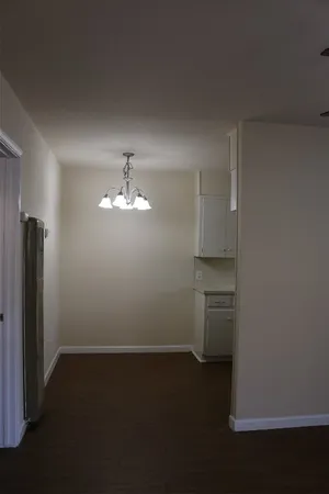 an empty room with closet and windows