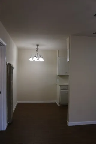 an empty room with closet and windows