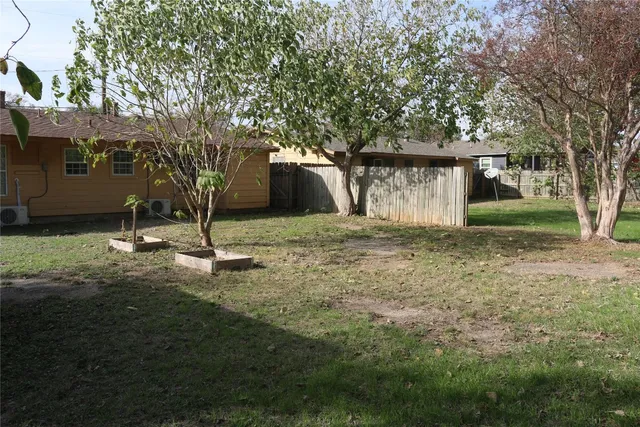 a house that has a tree in front of it