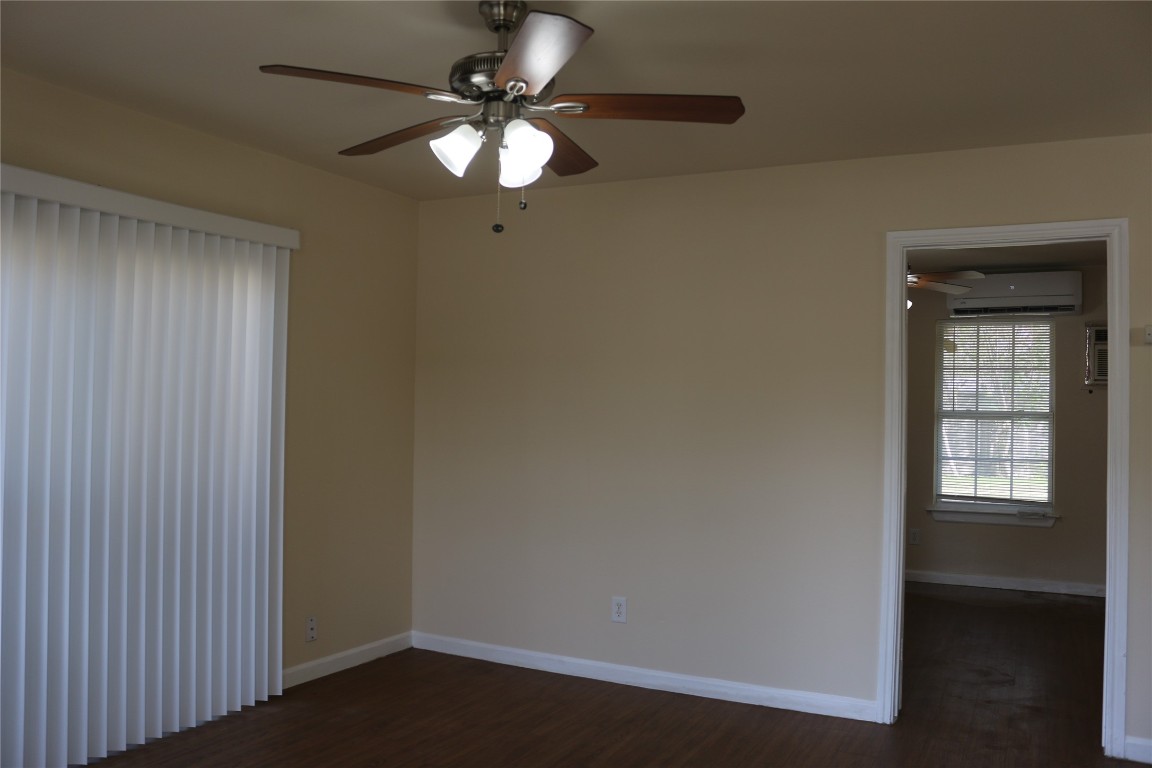 1705 Walnut Street, Unit 3 Georgetown, TX 78626 - Photo 3 of 21 an empty room with wooden floor fan and windows