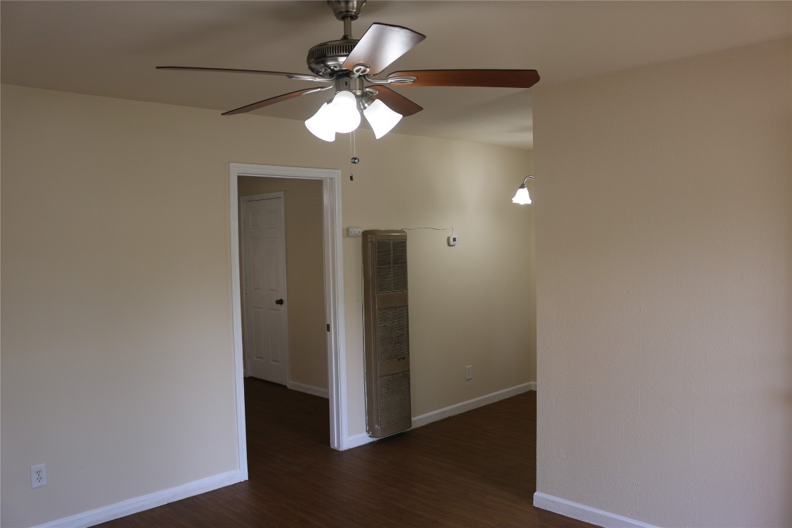 1705 Walnut Street, Unit 3 Georgetown, TX 78626 - Photo 4 of 21 an empty room with wooden floor and chandelier fan