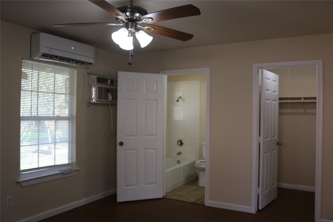 1705 Walnut Street, Unit 3 Georgetown, TX 78626 - Photo 8 of 21 an empty room with closet and a chandelier fan