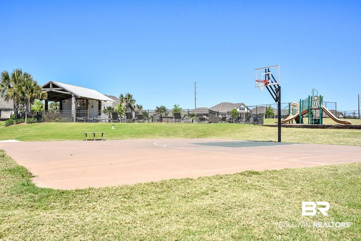 388 Garrison Boulevard Fairhope, AL 36532 - Photo 24 of 34 View of basketball court featuring a playground and a lawn