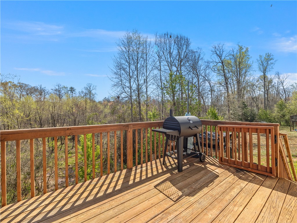 2520 Linmar Circle Anderson, SC 29621 - Photo 35 of 50 A spacious wooden deck provides ample room for outdoor entertaining, surrounded by verdant tree-lined views.