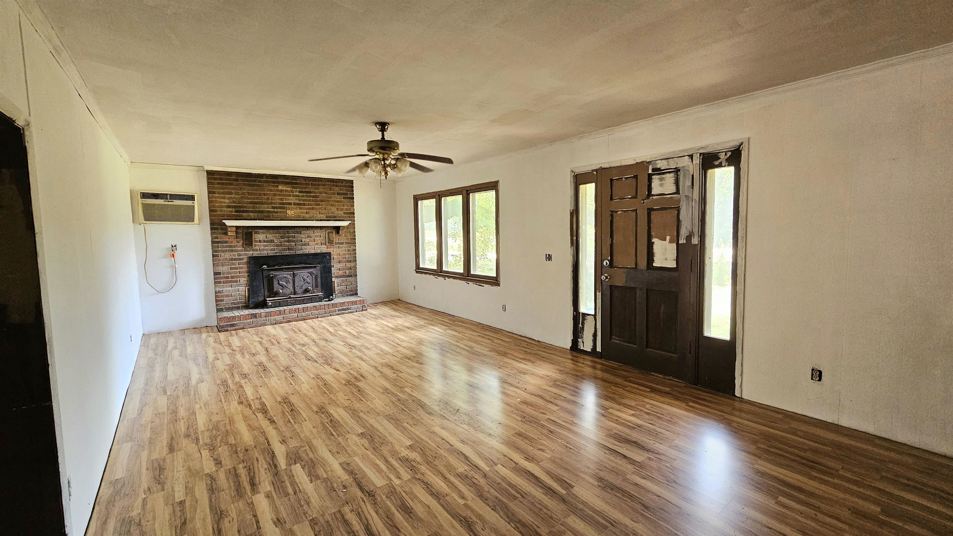 1570 Bear Creek Road Collinwood, TN 38450 - Photo 2 of 12 wooden floor fireplace and natural light in room