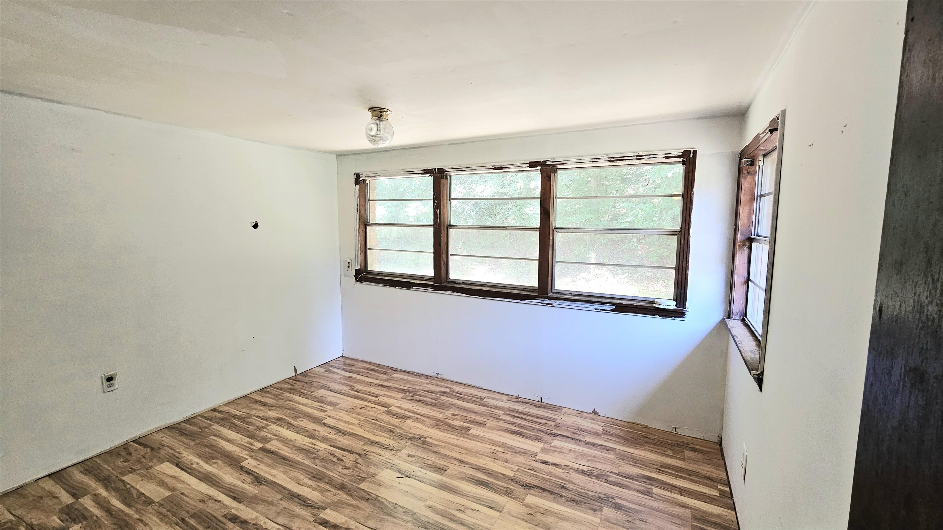 1570 Bear Creek Road Collinwood, TN 38450 - Photo 6 of 12 a view of empty room with wooden floor and fan