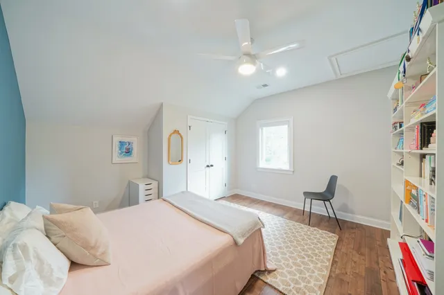 a bedroom with a large bed couch and window