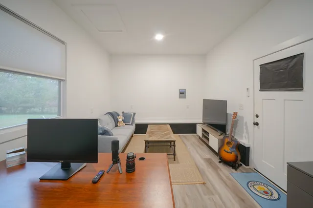 a view of a house with a yard and sitting area