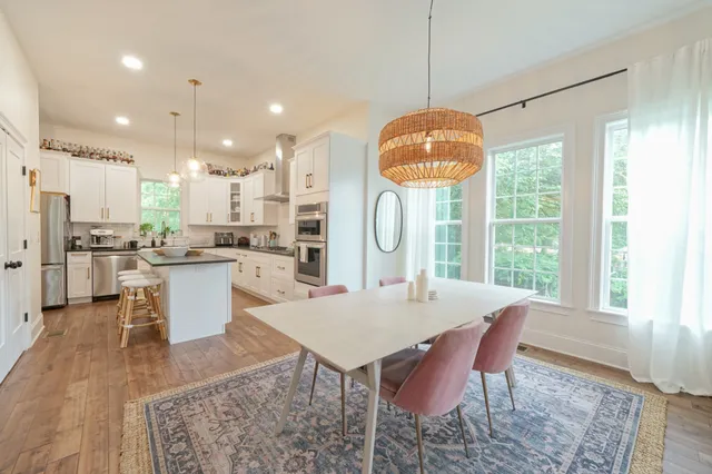 a large kitchen with a table and chairs
