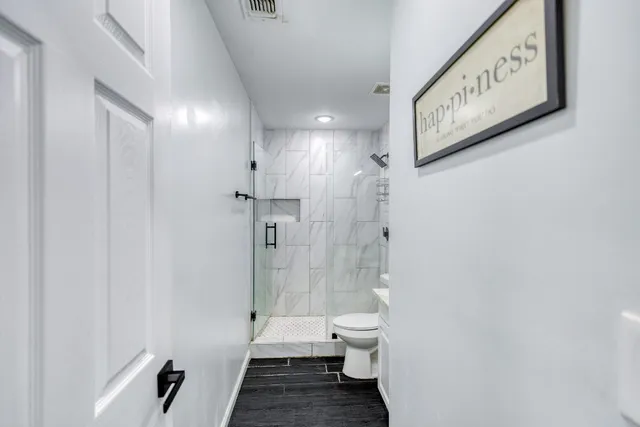 a bathroom with a toilet sink and shower