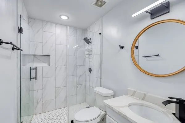 a bathroom with a sink toilet and shower