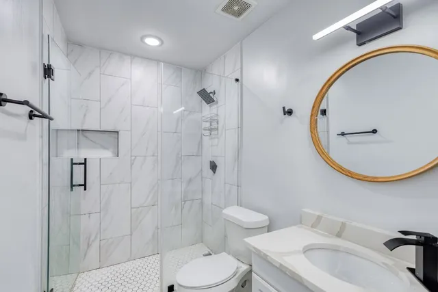 a bathroom with a sink toilet and shower