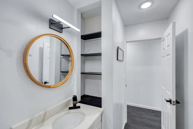 a bathroom with a sink a mirror and a shower