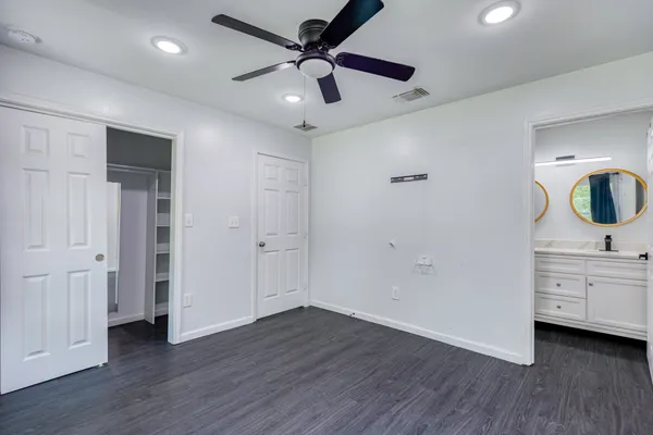 a view of a livingroom with wooden floor and white cabinet