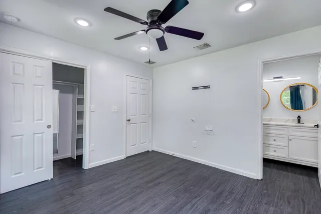 a view of a livingroom with wooden floor and white cabinet