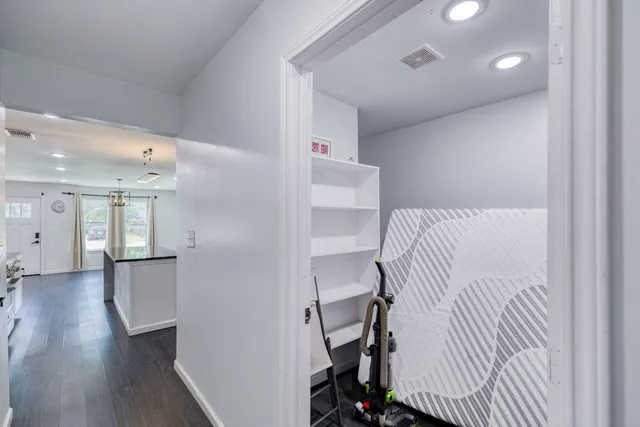 a view of a bedroom with wooden floor