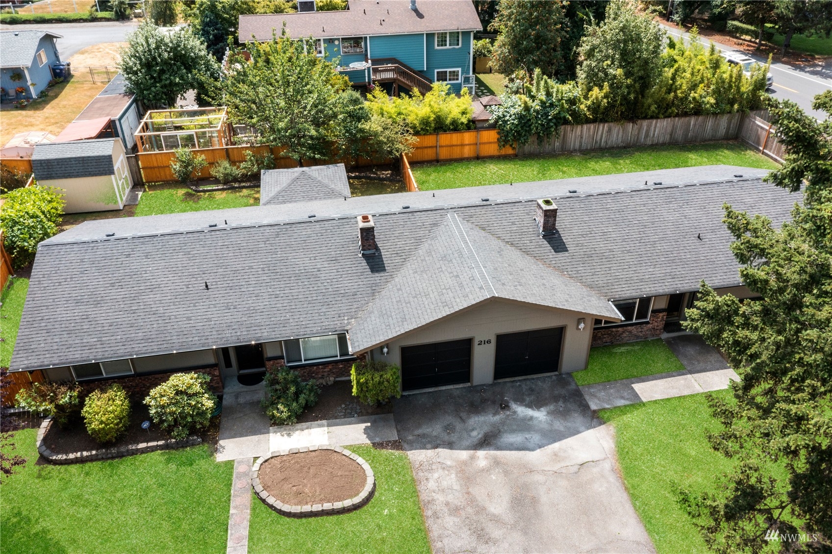 an aerial view of a house with a yard and a sitting area