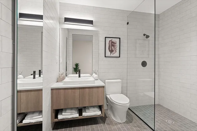 a bathroom with a toilet a sink and mirror