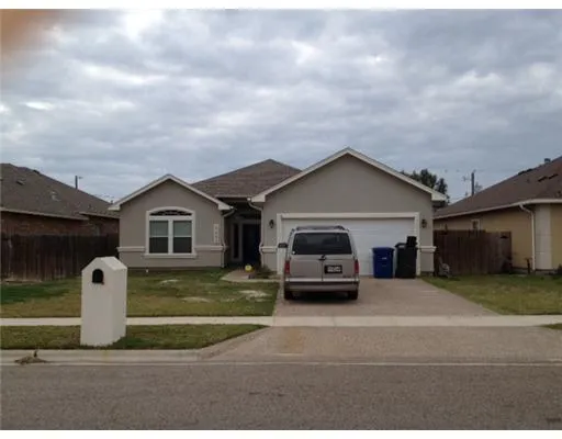a car parked in front of white house