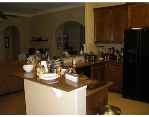 a kitchen with sink a refrigerator and cabinets