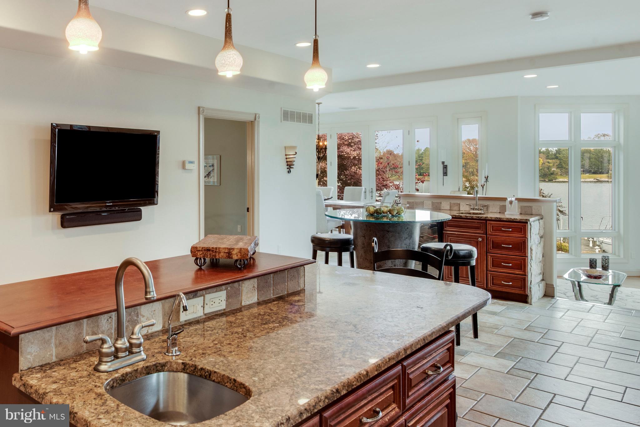 1795 Beachfield Road Annapolis, MD 21409 - Photo 13 of 49 a kitchen with kitchen island a sink counter and chairs