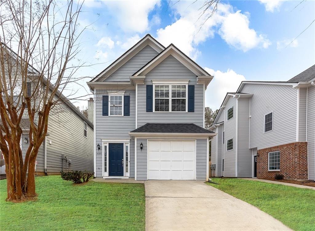 a front view of house with yard and green space