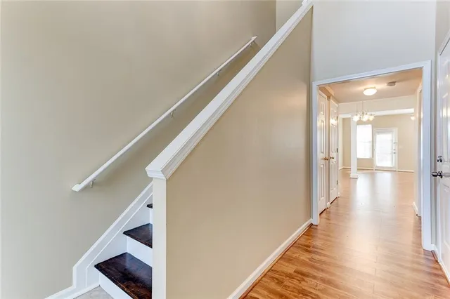 a view of a hallway with wooden floor and staircase