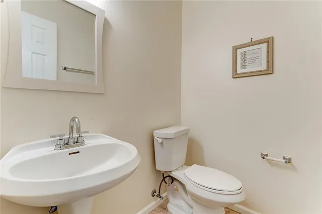 a white toilet sitting next to a bathroom sink