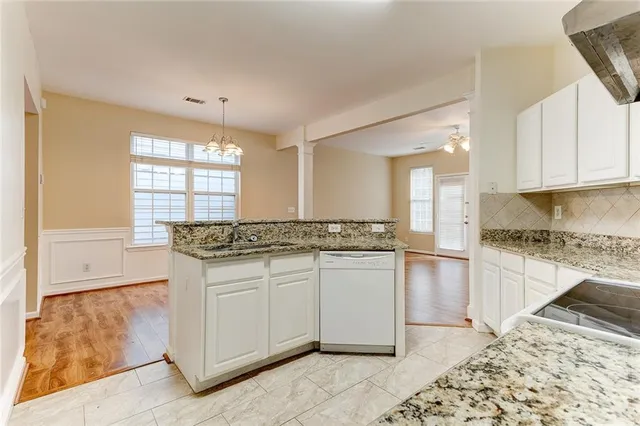a kitchen with stainless steel appliances granite countertop a sink and a stove