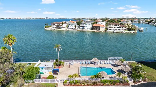 an aerial view of a house with a yard and lake view