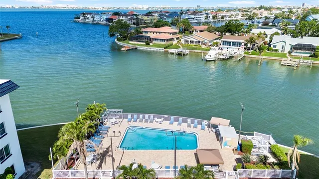 an aerial view of a house with a garden and lake view