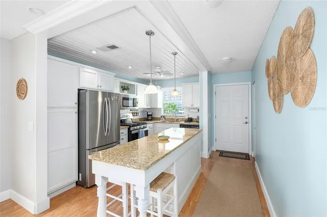 a kitchen with a refrigerator a sink and a stove