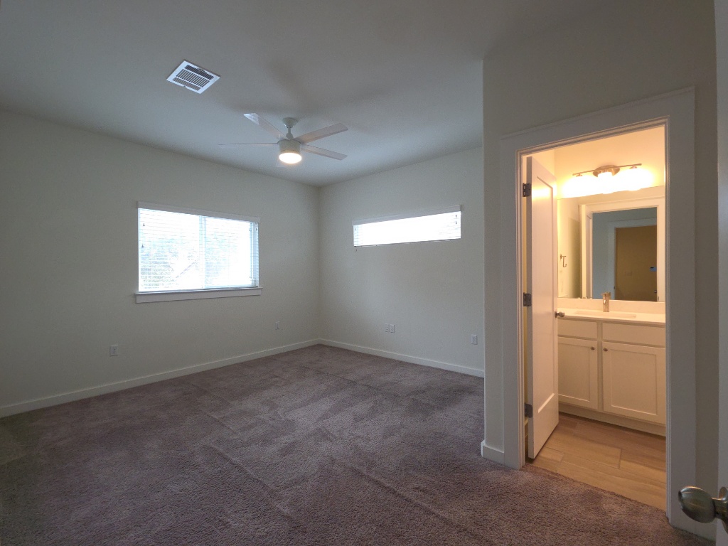 6800 Menchaca Road, Unit 42 Austin, TX 78745 - Photo 13 of 23 Secondary bedroom with carpet and en suite bathroom