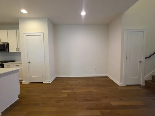 a view of a room with wooden floor and a sink