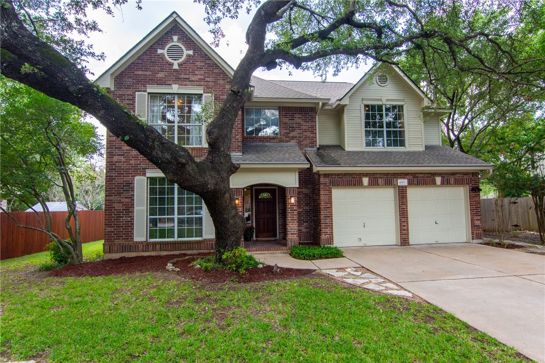 a front view of a house with a garden and plants
