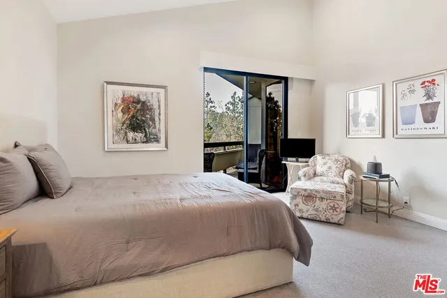 a bedroom with a bed and a large mirror