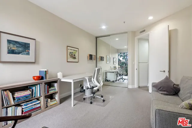 a bedroom with furniture and a book shelf