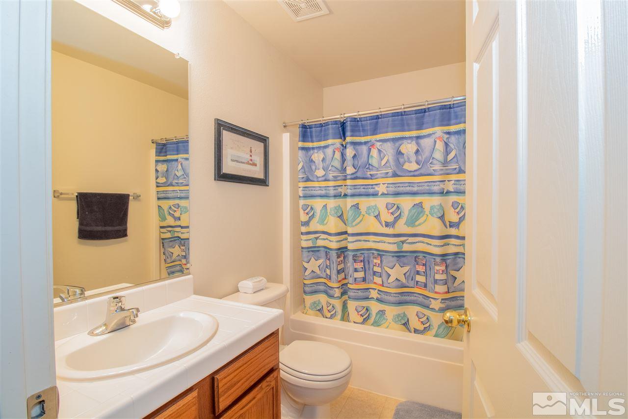 4027 Kings Row Reno, NV 89503 - Photo 6 of 17 a bathroom with a sink a toilet and a shower curtain