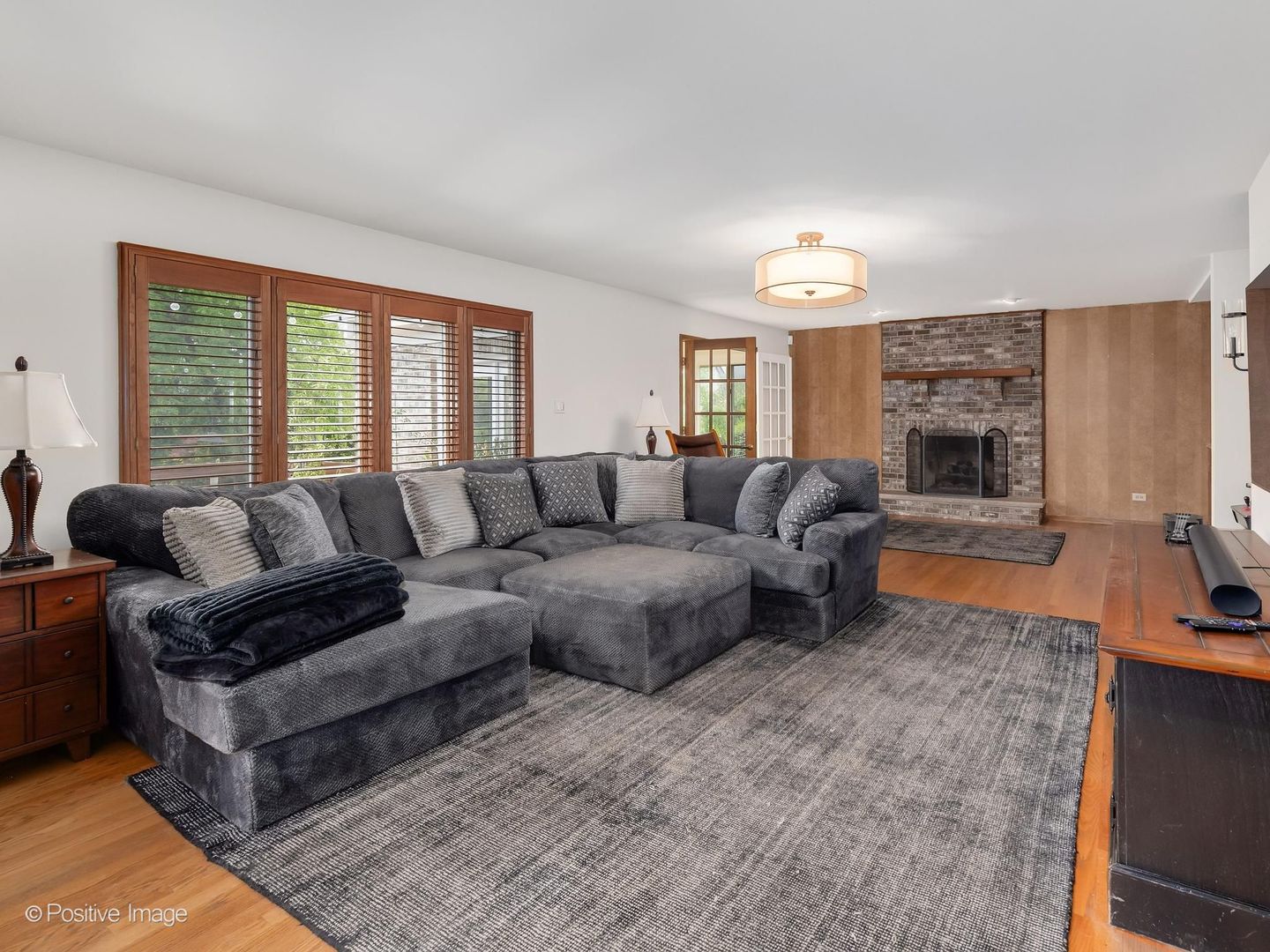 6451 Garfield Ridge Court Burr Ridge, IL 60527 - Photo 14 of 28 a living room with furniture a fireplace and a flat screen tv